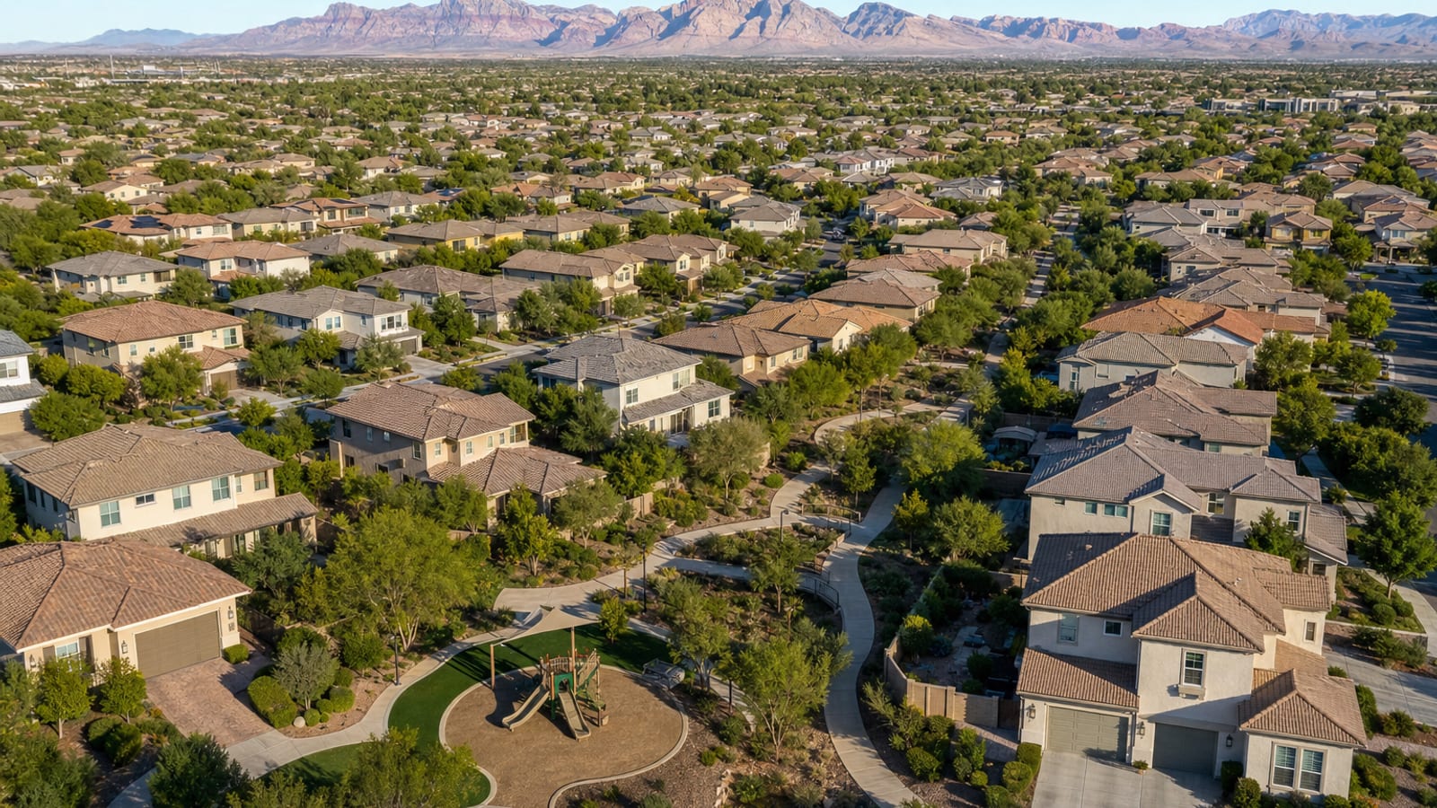 The Paseos Summerlin established village aerial showing mature tree-lined neighborhoods and Mediterranean architecture across the central-west Summerlin footprint
